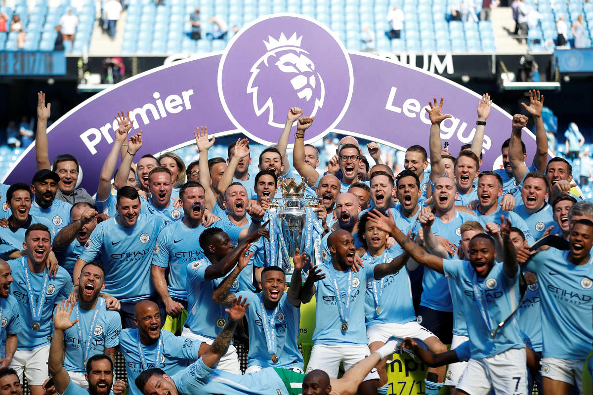 Triumphant: Manchester City celebrate with the Premier League trophy on Sunday. Reuters