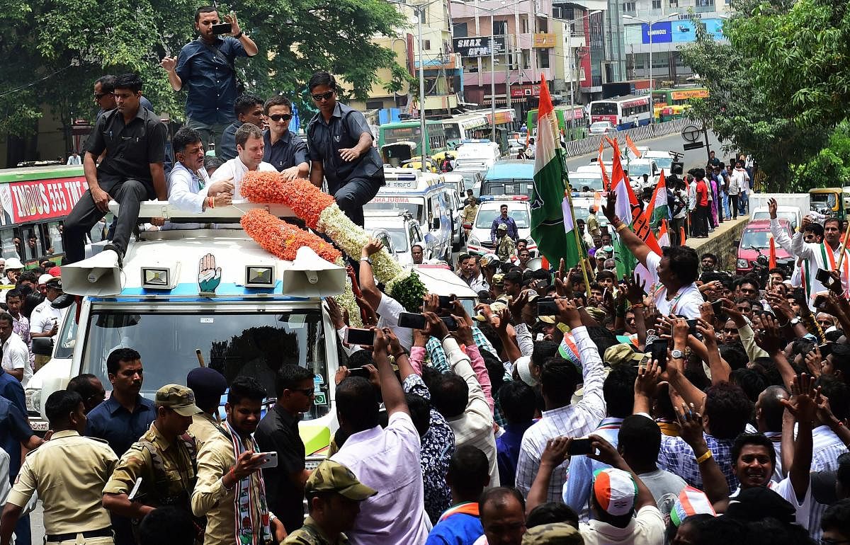 AICC President Rahul Gandhi waves at his supporters during a road show ahead of the Karnataka Assembly election in Bengaluru on Wednesday. PTI Photo