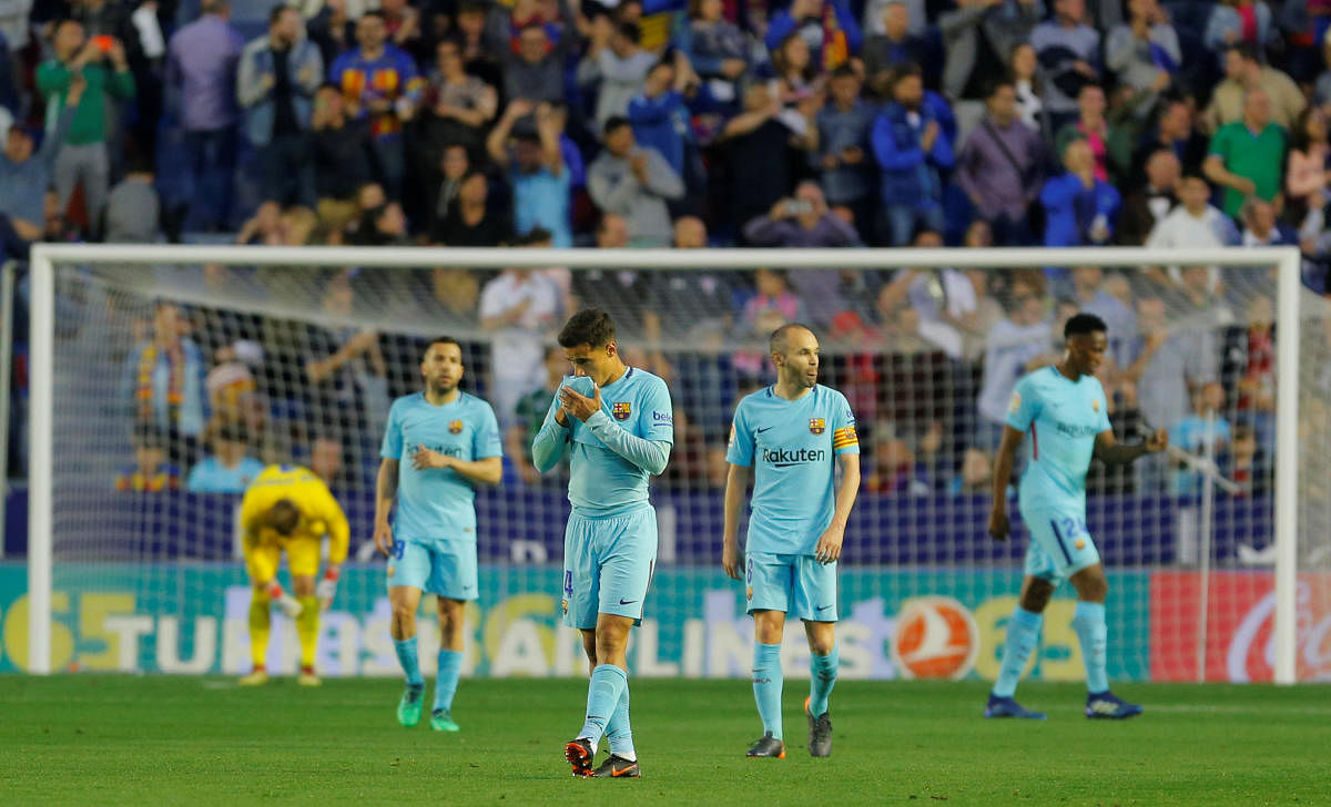 Barcelona's Philippe Coutinho and Andres Iniesta look dejected after losing to Levante. REUTERS