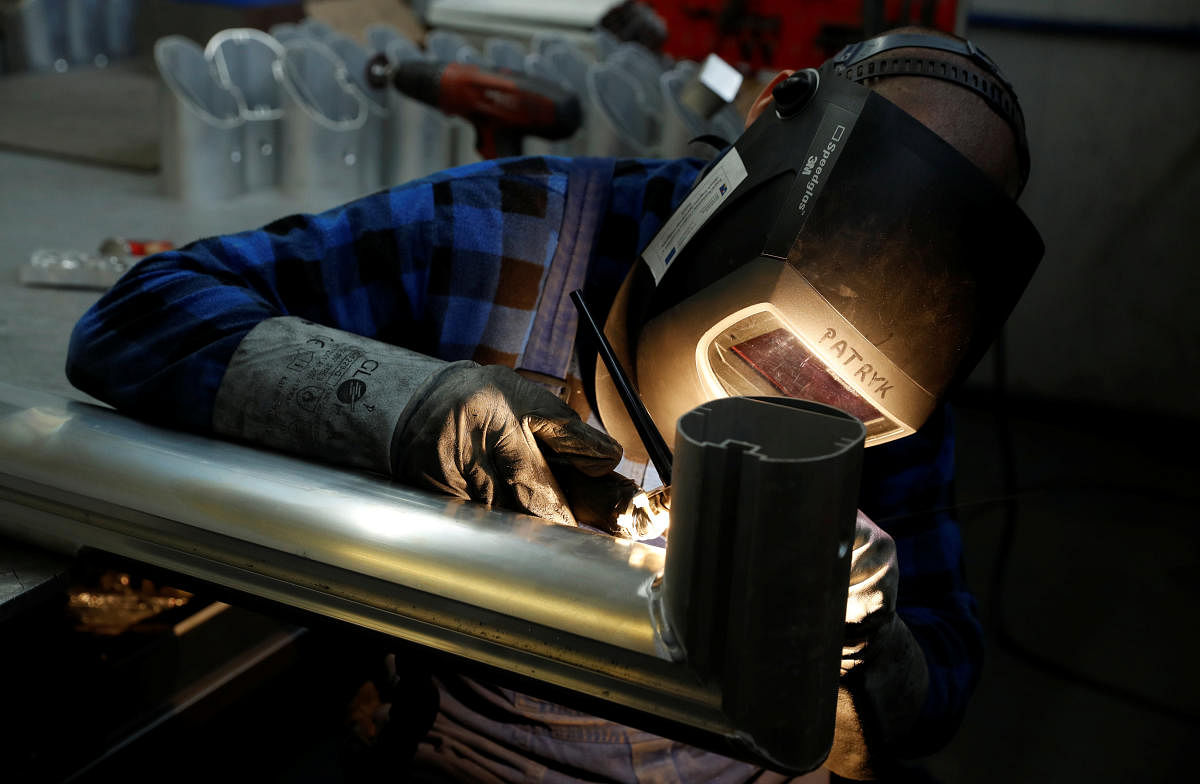 A worker welds the aluminium part of a goal at Interplastic, a Polish manufacturing company who are supplying the football goalposts for the 2018 World Cup finals in Russia, in Chwaszczyno, Poland, May 16, 2018. Picture taken May 16, 2018. REUTERS/Kacper