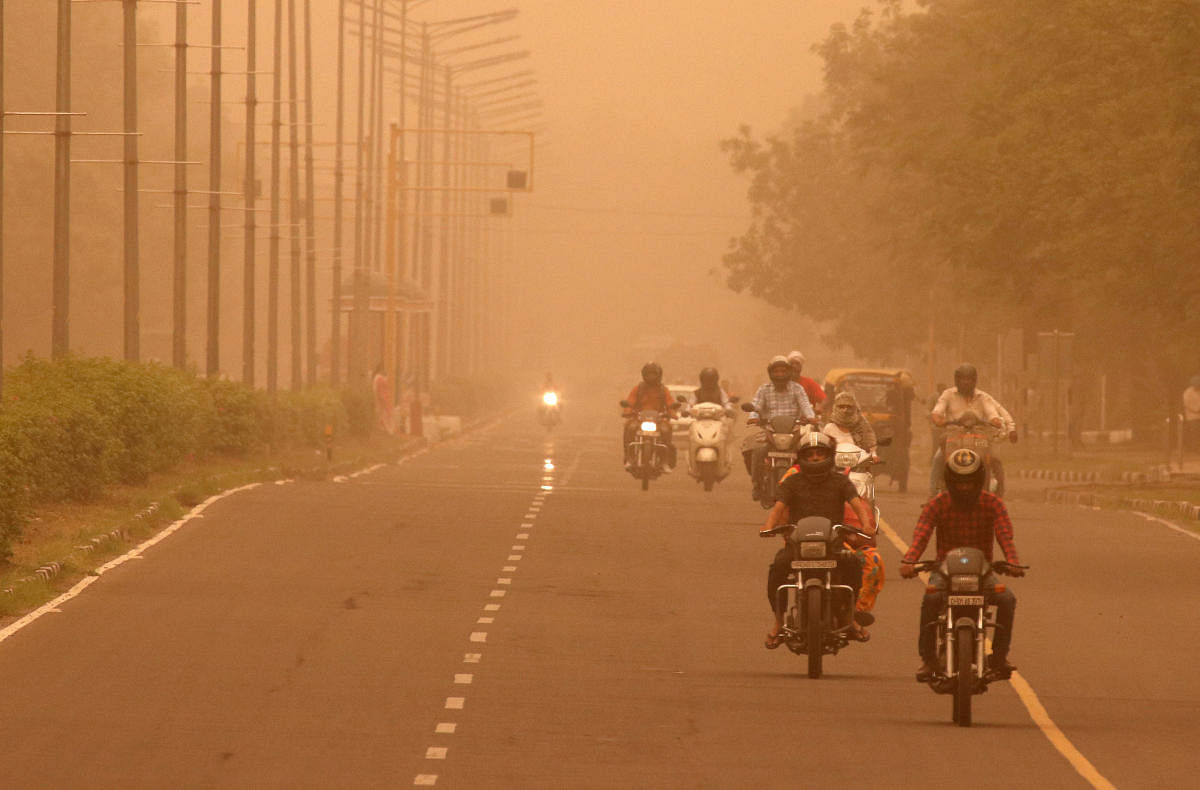 Commuters make their way amidst haze and dust in Chandigarh. (Reuters)
