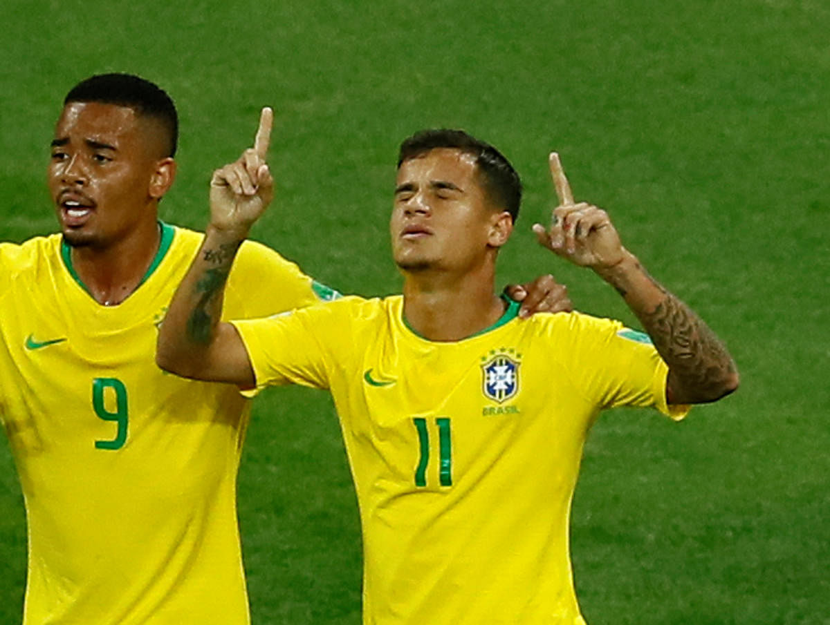 Philippe Coutinho (right) celebrates with Gabriel Jesus after scoring against Switzerland. REUTERS