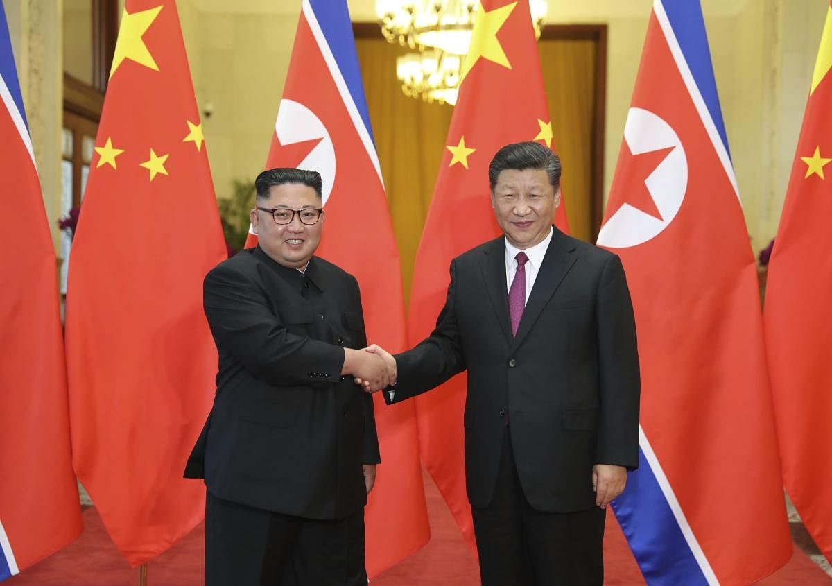 Chinese President Xi Jinping poses with North Korean leader Kim Jong Un. AP/PTI file photo