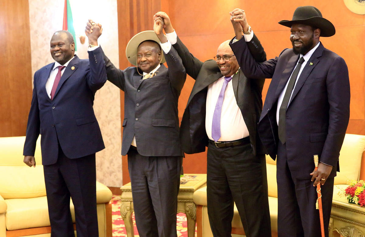 Sudan's President Omar Al-Bashir hold hands with Uganda's President Yoweri Museveni, South Sudan's President Salva Kiir and South Sudan rebel leader Riek Machar during a South Sudan peace meeting as part of talks to negotiate an end to a civil war that br