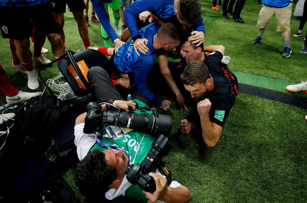Croatia players celebrate next to an AFP photographer Yuri Cortez after Mario Mandzukic scored their second goal. REUTERS