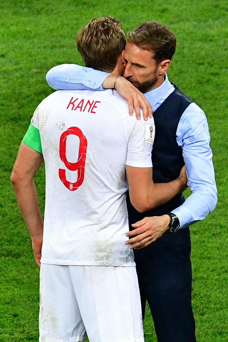 SHOULDER TO CRY England coach Gareth Southgate embraces his captain Harry Kane after the semifinal defeat against Croatia. AFP