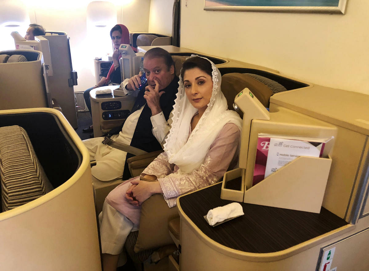 Ousted Pakistani Prime Minister Nawaz Sharif and his daughter Maryam sit on a Lahore-bound flight due for departure, at Abu Dhabi International Airport, UAE on Friday. (REUTERS/Drazen Gorgic)