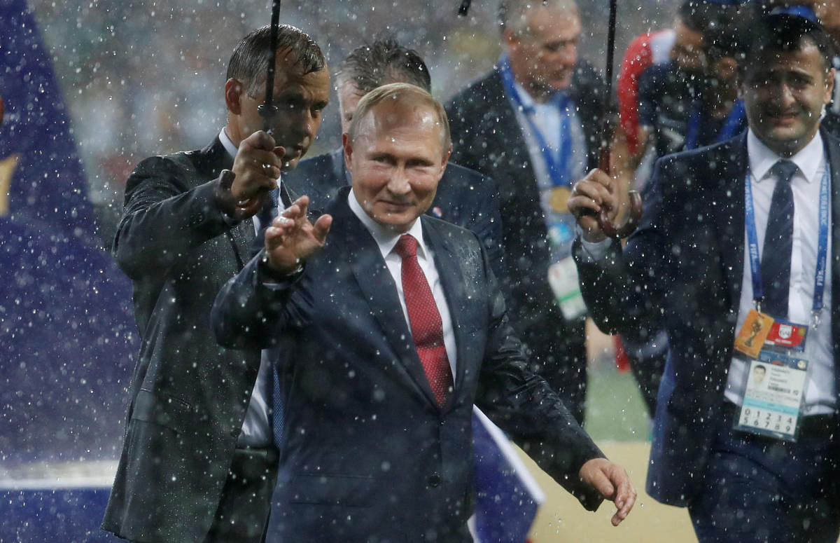 President of Russia Vladimir Putin on the pitch after the medals ceremony. REUTERS