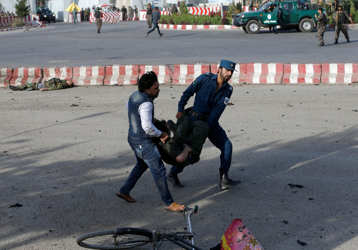 Members of Afghan security forces carry a wounded man at the site of a blast in Kabul, Afghanistan. (Reuters Photo)
