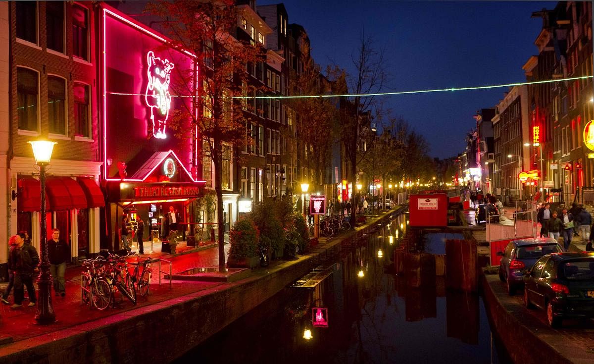 In this file photo taken on October 12, 2011 people walk through the red-light district, known as De Wallen in Amsterdam. AFP photo