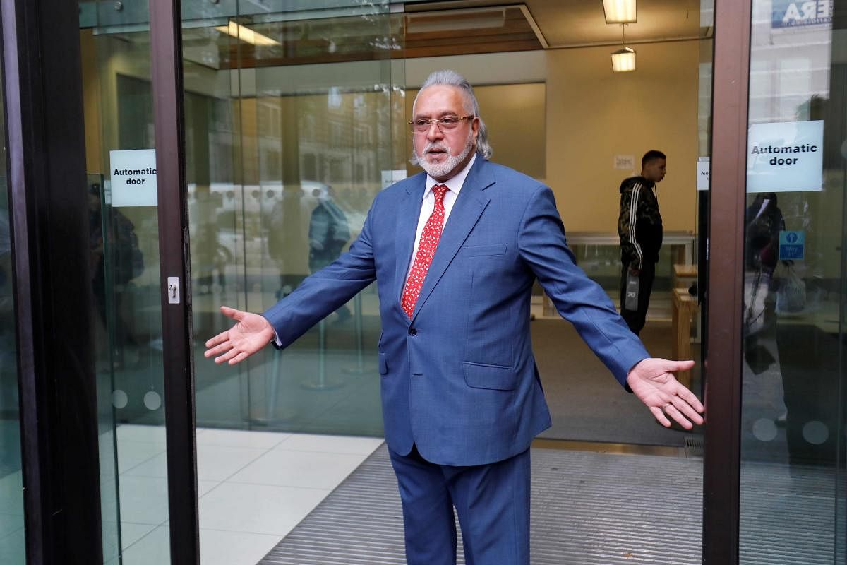 Vijay Mallya gestures to members of the media as he leaves after appearing at Westminster Magistrates Court in central London on Tuesday. AFP