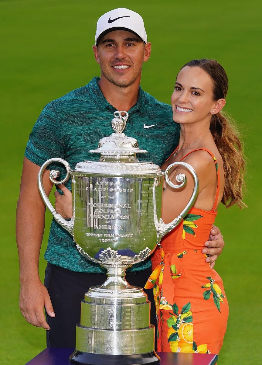 ON CLOUD NINE Brooks Koepka of the US poses with his girlfriend, Jena Sims, and the Wanamaker Trophy after winning the PGA Championship on Sunday. AFP