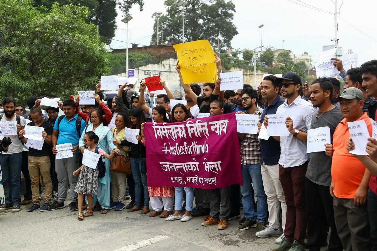 Nepali activists take part in protest rally, demanding justice after the rape and murder of a 13-year-old girl, in Kathmandu on August 25, 2018. - One person was killed and dozens injured in Nepal when police opened fire on protesters demanding action ove