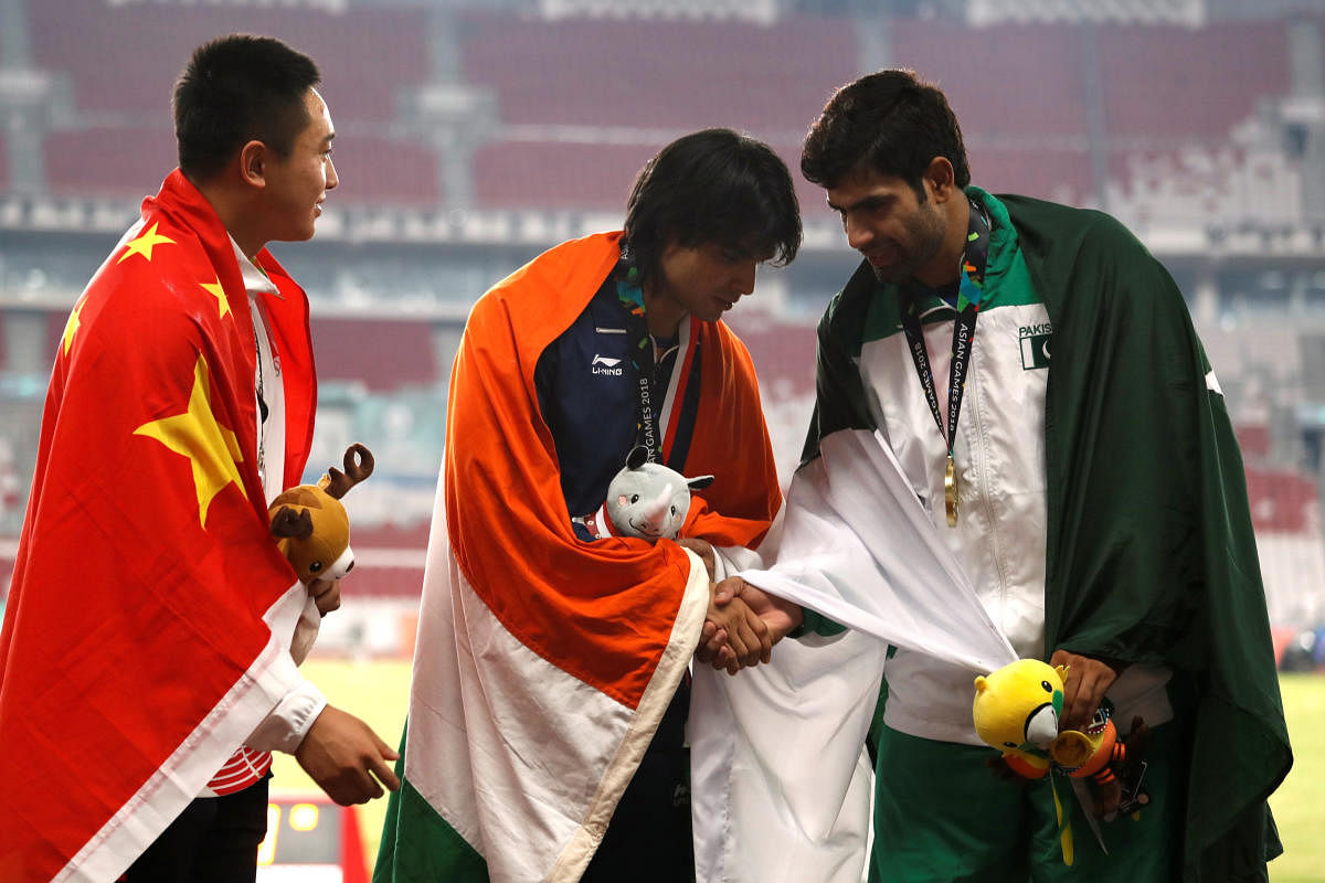 Asian Games' gold-medallist Neeraj Chopra (centre) is flanked by silver-medallist Qizhen Liu of China (left) and bronze-medallist Arshad Nadeem of Pakistan. REUTERS