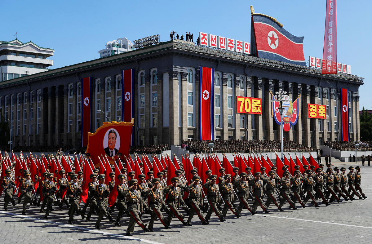 Soldiers march with the portrait of North Korean founder Kim Il Sung during a military parade marking the 70th anniversary of country's foundation in Pyongyang, North Korea, September 9, 2018. REUTERS/Danish Siddiqui