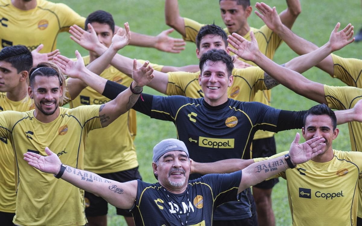 Argentine legend Diego Maradona (foreground) gestures with the players during his first training session as coach of Mexican football club Dorados on Monday. AFP
