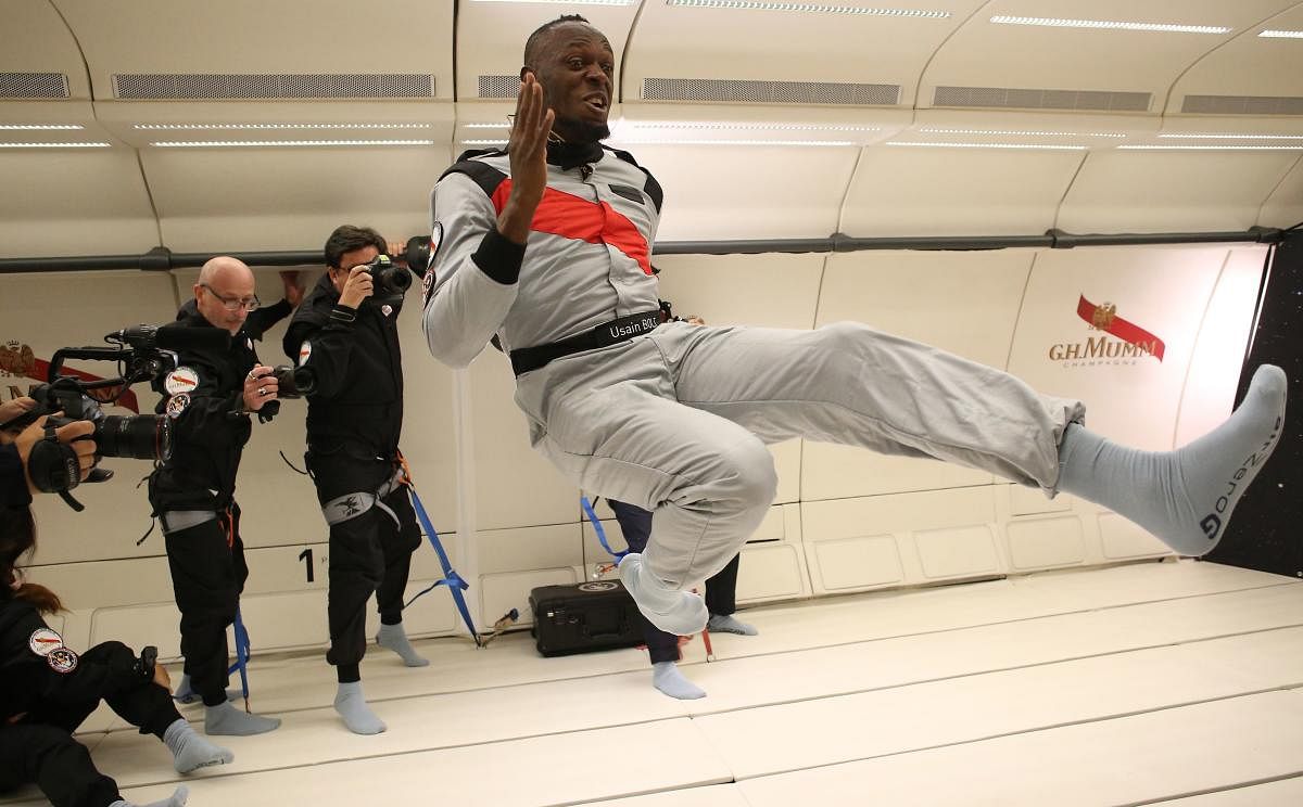 This photo released by Mumm/Novespace shows Usain Bolt (centre) in zero-gravity conditions in an aircraft on Wednesday above Reims. AFP