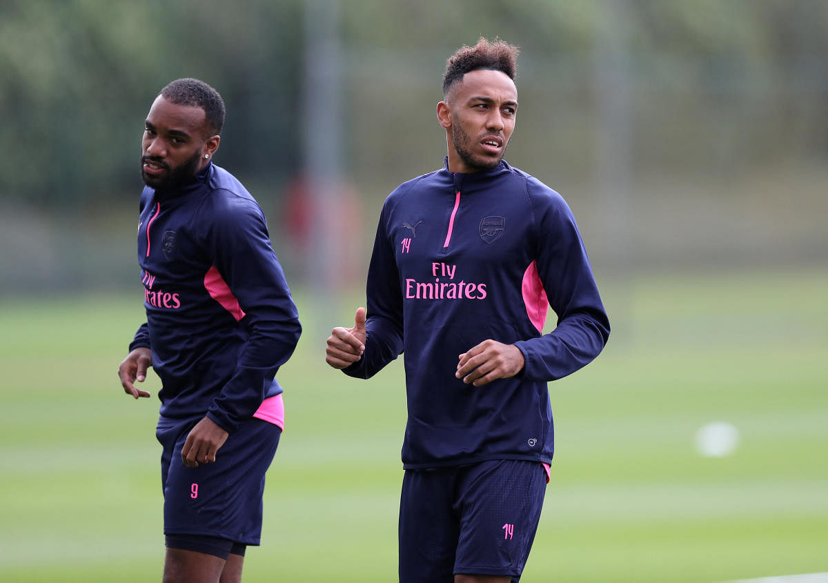 Arsenal strikers Alexandre Lacazette (left) and Pierre-Emerick Aubameyang will be gunning for a strong start as the Europa League kicks off today. REUTERS