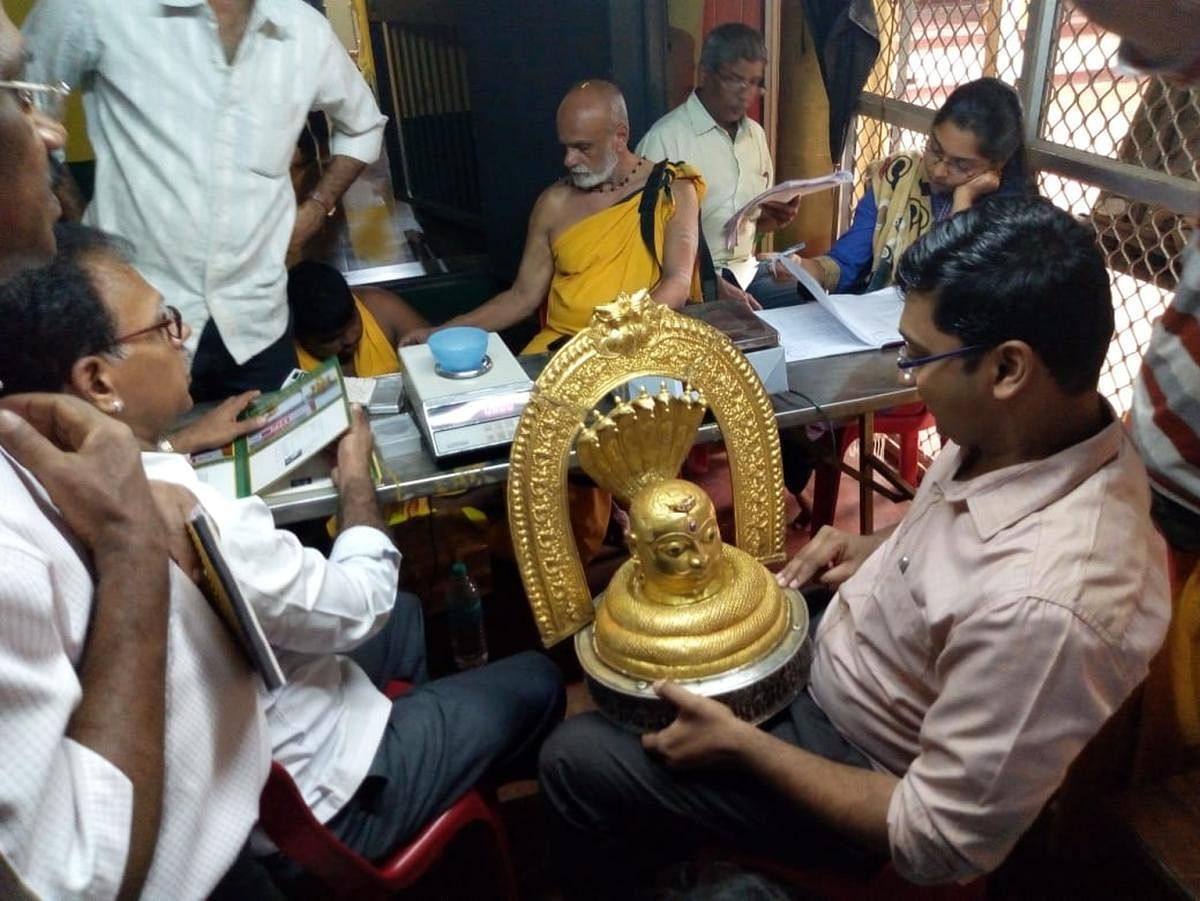 Deputy Commissioner S S Nakul inspects a jewellery after taking over administration of the Gokarna temple on Wednesday. dh photo