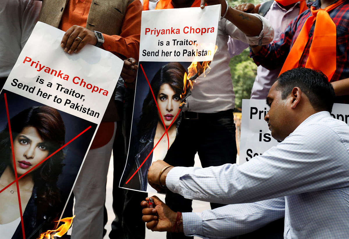 Supporters of Hindu Sena, a right wing group, burn posters of Bollywood actor Priyanka Chopra during a protest, in New Delhi on Saturday. REUTERS