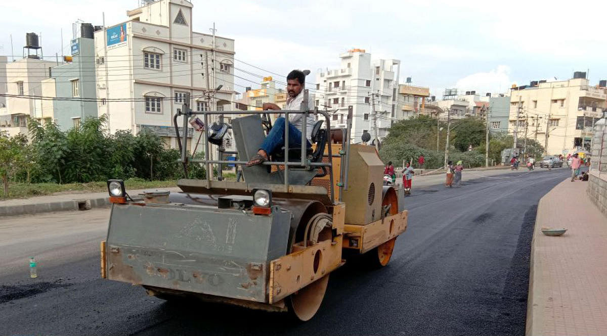 BBMP workers patching up potholes after the high court order.