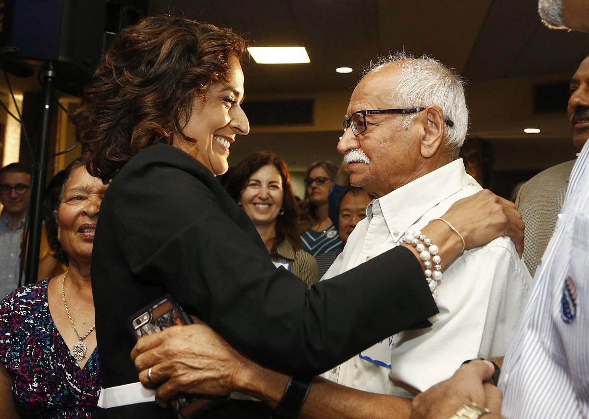 Democratic candidate for the 8th Congressional District, Dr. Hiral Tipirneni, left, hugs her father, Kishor Vyas, as she joins supporters after polls closed in her run against Republican Debbie Lesko as each candidate looks to fill the seat vacated by Rep