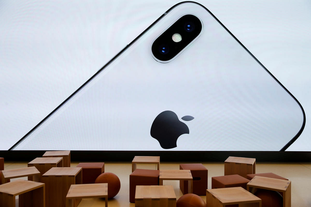 FILE PHOTO: An iPhone X is seen on a large video screen in the Apple visitor centre in US. Reuters