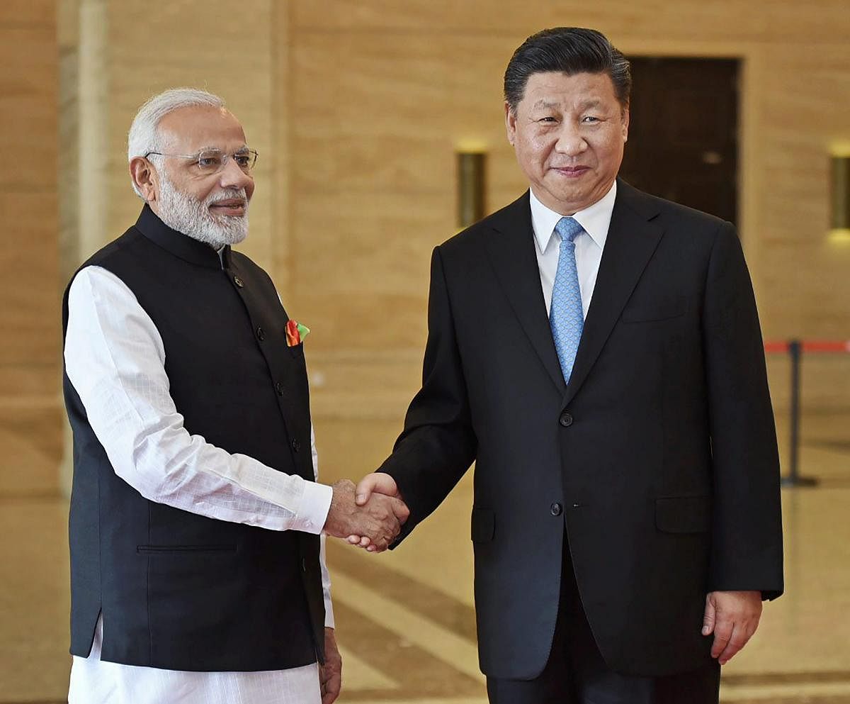 Prime Minister Narendra Modi shakes hands with Chinese President Xi Jinping during their meeting, in Wuhan, China on Friday. PTI Photo