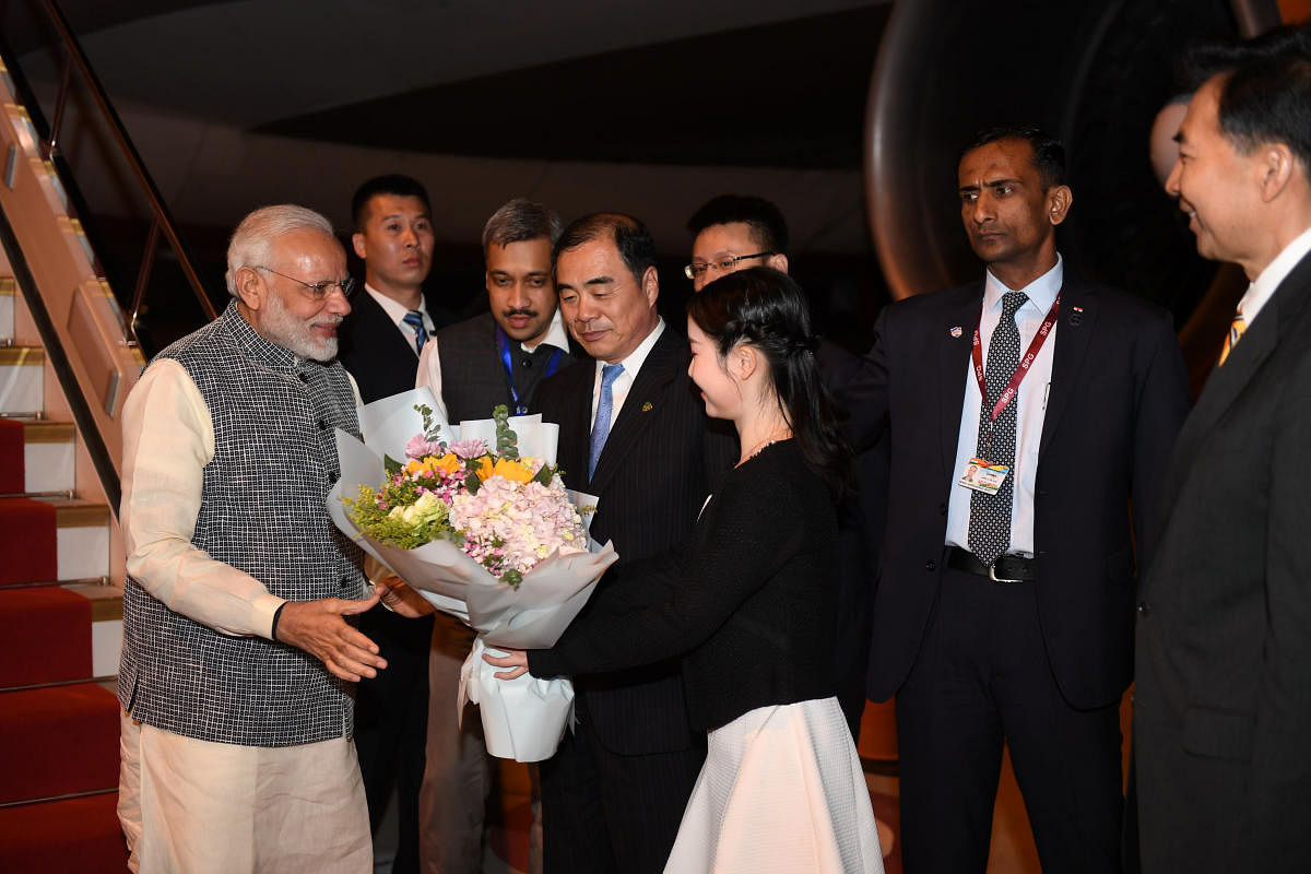 India's Prime Minister Narendra Modi is greeted by Chinese officials as he arrives at the airport in Wuhan, Hubei province, China early April 27, 2018. Reuters.