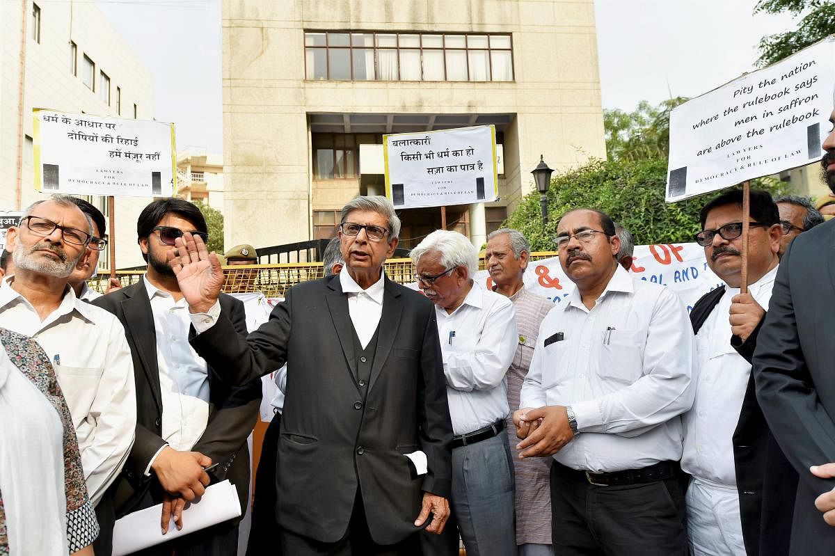 Lawyers display placards during a silent march to Bar Council of India to present a memorandum demanding action against the guilty lawyers of Jammu who came out in support of the culprits in the Kathua case, in New Delhi. (PTI File Photo)