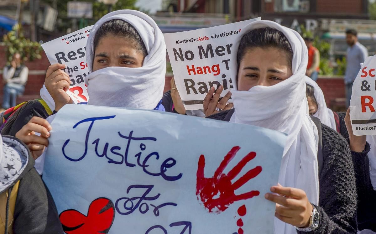 Students hold placards at a peaceful sit-in protest demanding justice for Kathua rape case victim, in Srinagar on Tuesday. (PTI file photo for representation)