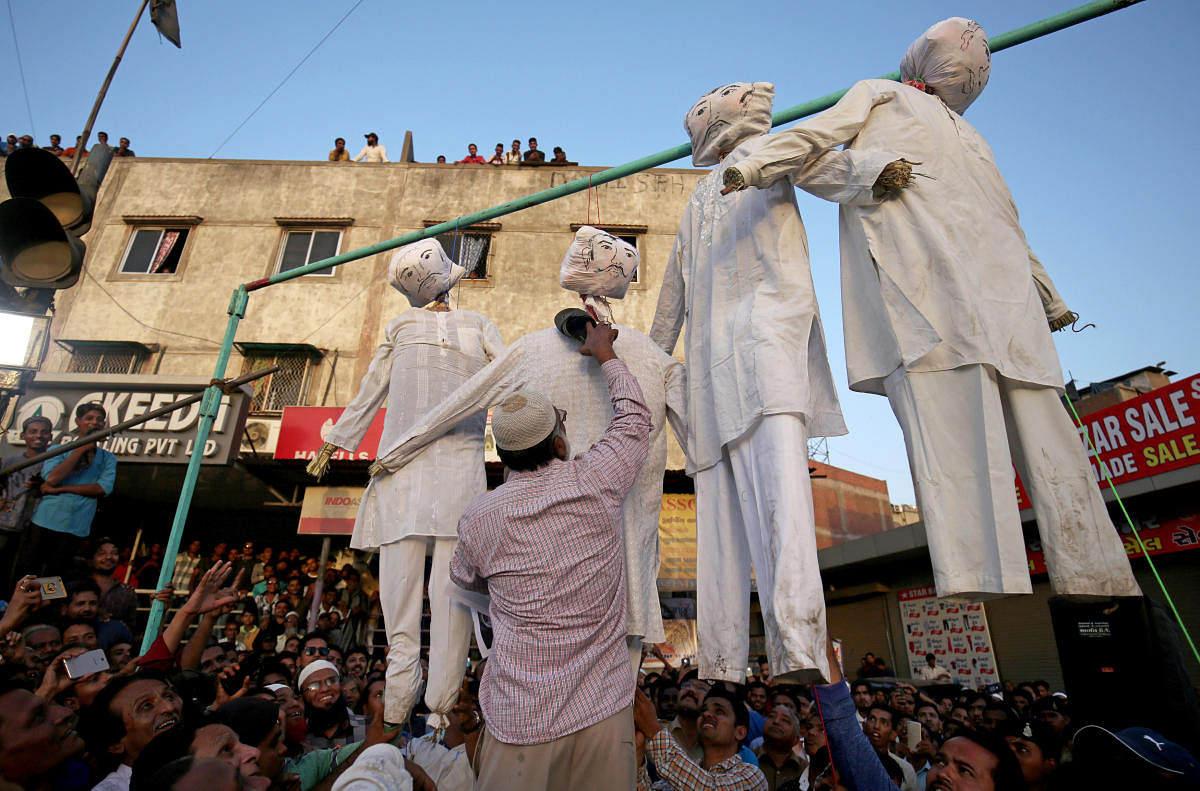 A man beats an effigy of one of the rapists at a protest against the rape of an eight-year-old girl, in Kathua, near Jammu, a teenager in Unnao, Uttar Pradesh state, and an eleven-year-old girl in Surat, in Ahmedabad. Reuters. 