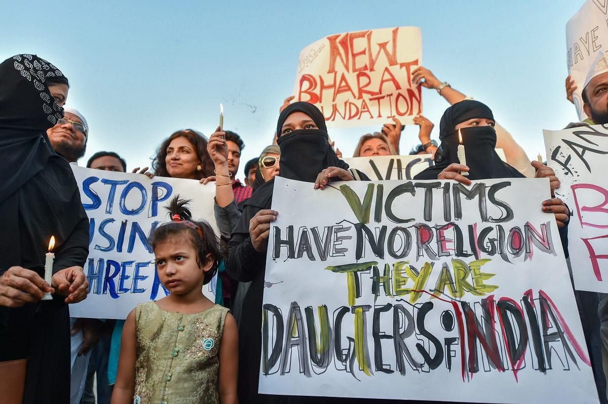 People take part in a candlelight march at the India Gate in protest over Kathua gangrape case, in New Delhi on Friday. PTI Photo