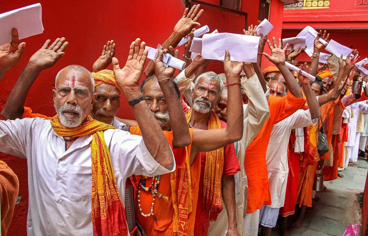 Sadhus wait in a queue to get themselves registered for Amarnath Yatra. PTI file photo.