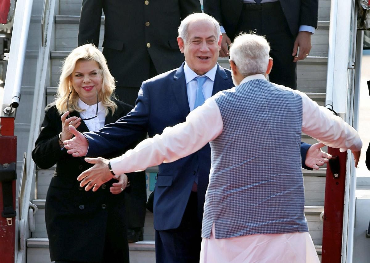 Prime Minister Narendra Modi welcomes Israeli PM Benjamin Netanyahu and his wife Sarah on their arrival at Air Force station Palam in New Delhi. PTI File Photo.