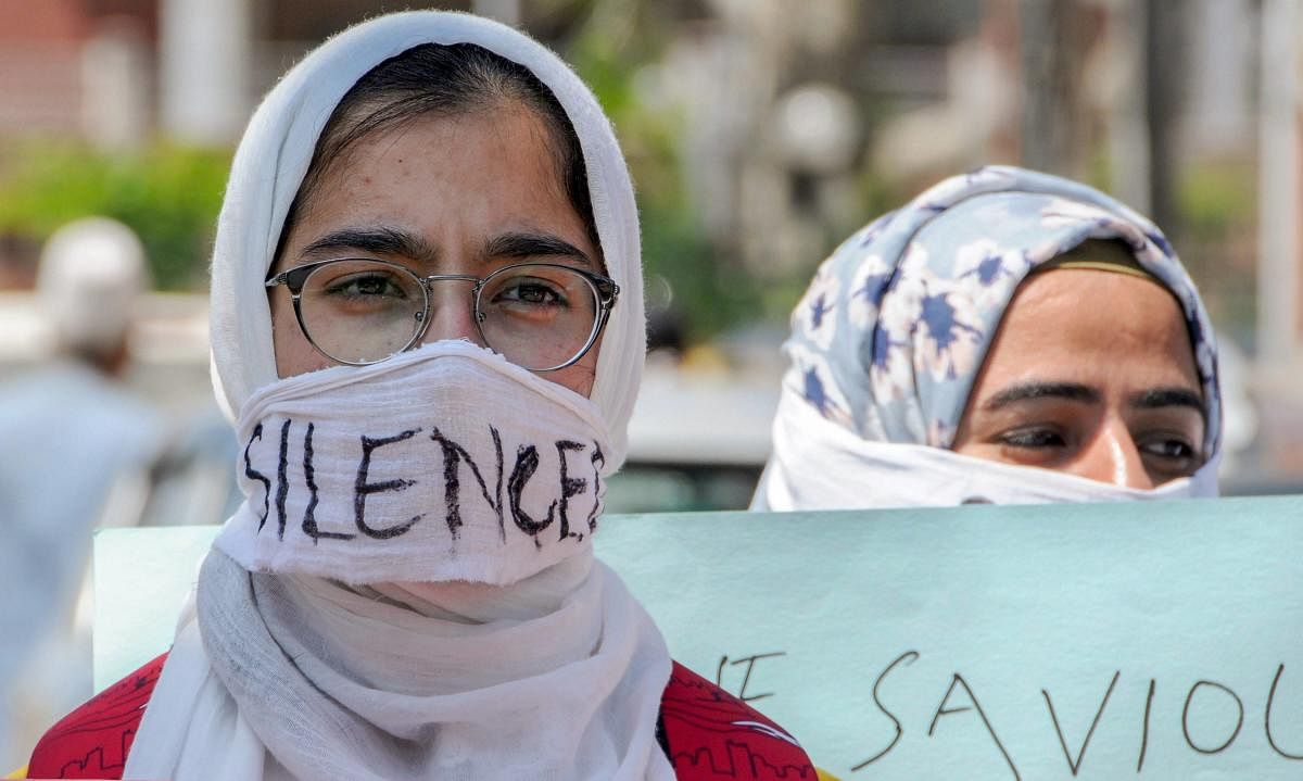 Students cover their faces during a protest seeking justice for 8-year-old Kathua girl who was allegedly raped and murdered, in Srinagar. PTI file photo