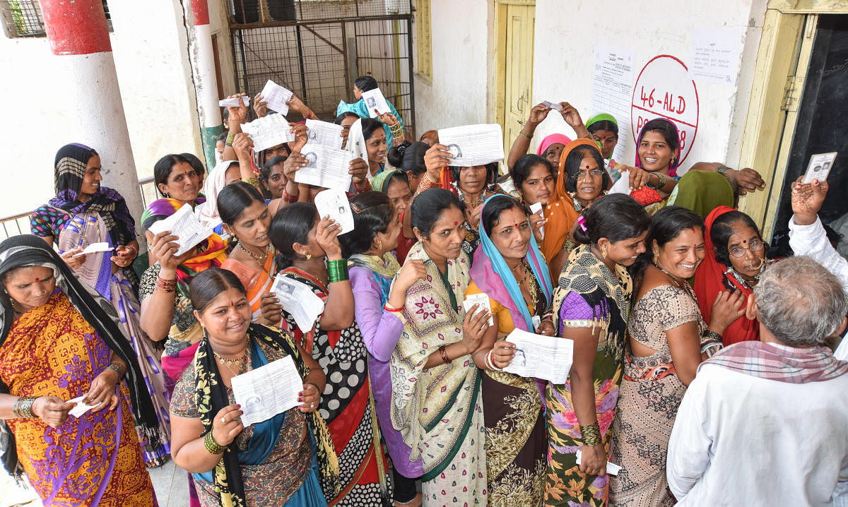 Women stand in Queue to exercise their franchise for Assembly Election at Korahalli village in Aland taluk in Kalaburagi District on Saturday. - Photo/ Prashanth HG