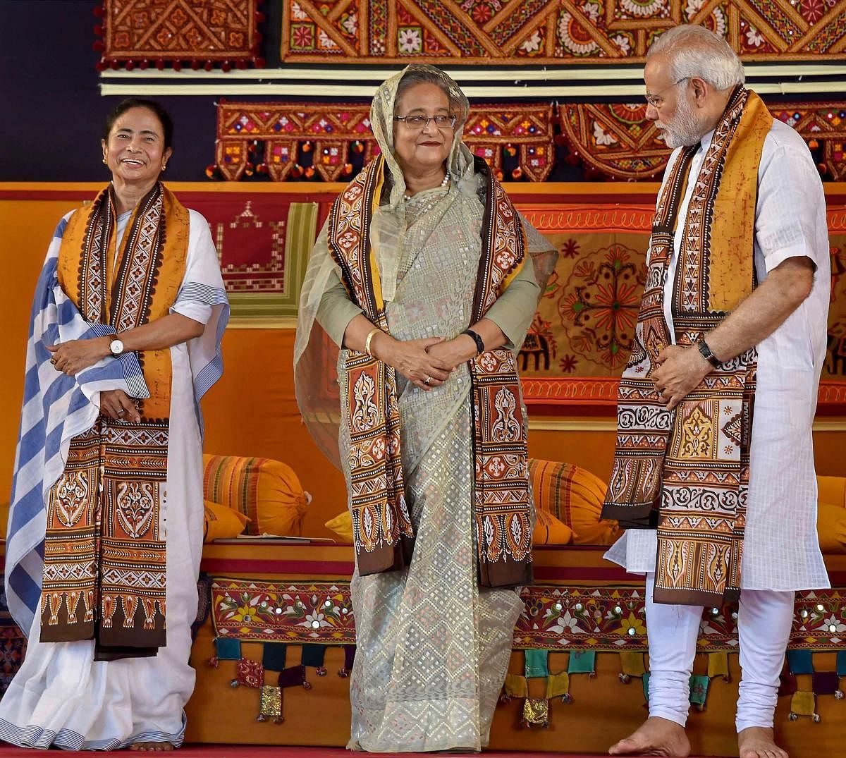 Prime Minister Narendra Modi speaks with his Bangladeshi counterpart Sheikh Hasina as West Bengal Chief Minister Mamata Banerjee looks on, during the annual convocation of Visva Bharati University, in Birbhum, on Friday. PTI Photo