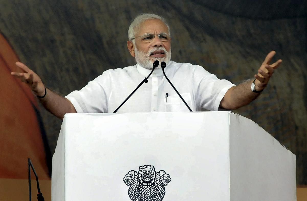 Prime Minister Narendra Modi addresses during the foundation stone laying ceremony of several projects, at Baliapur block of Dhanbad district, in Jharkhand, on Friday. (PTI Photo)