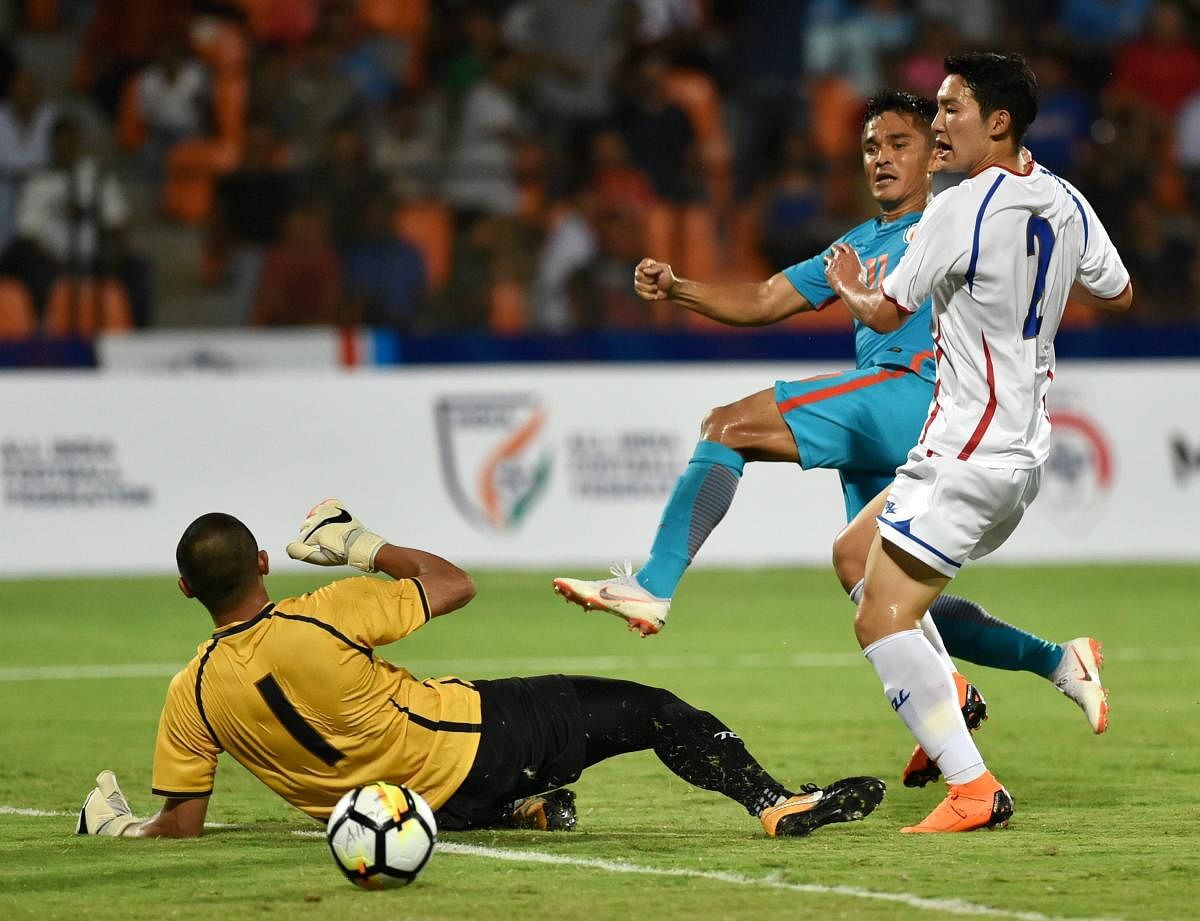 India's Sunil Chhetri (centre) scores past Chinese Taipei goalkeeper Pan Wen-chieh on Friday. PTI