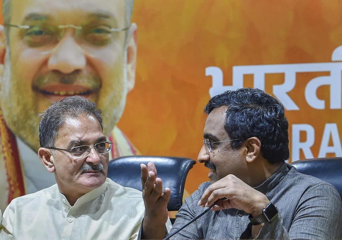 BJP in-charge for Jammu and Kashmir Ram Madhav with the former Dy Chief Minister Kavinder Gupta. PTI file photo