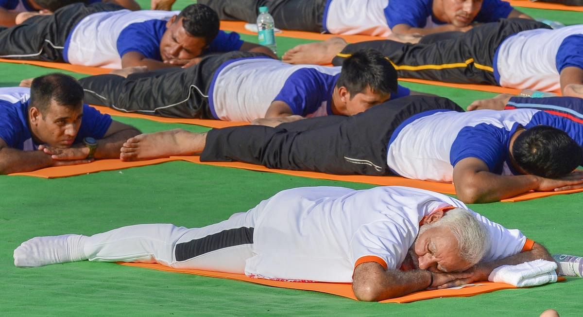 Prime Minister Narendra Modi performs yoga during a mass yoga event on 4th International Yoga Day at Forest Research Institute (FRI) ground in Dehradun, on Thursday. PTI file photo