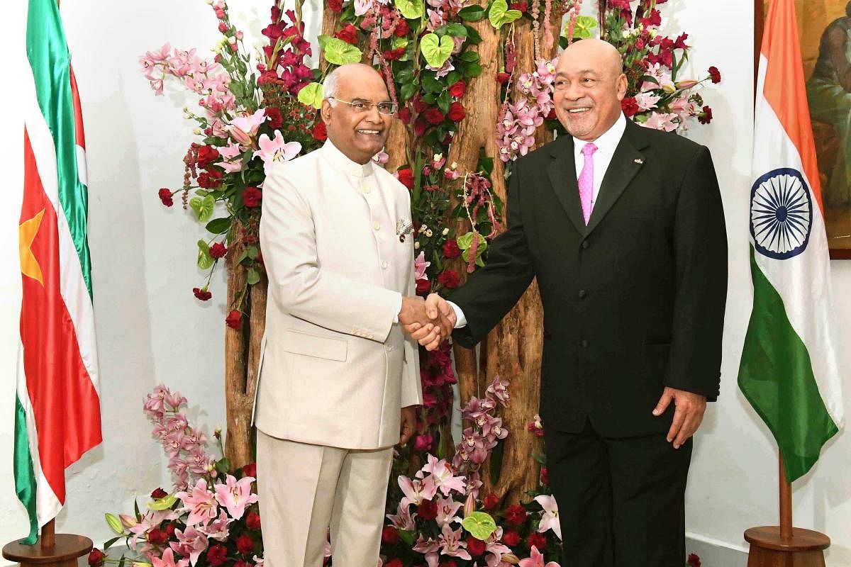 President Ram Nath Kovind shakes hands with his Surinamese counterpart Desire Delano Bouterse ahead of delegation-level meeting, in Suriname on Thursday, June 21, 2018.