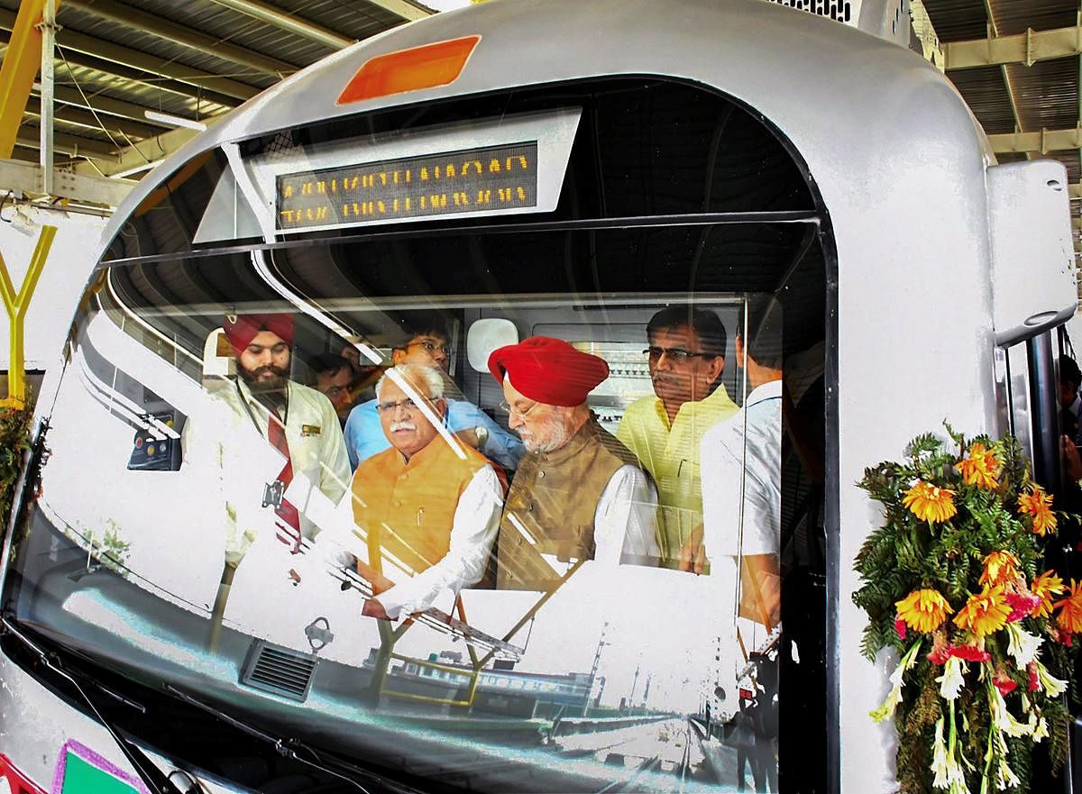 Haryana Chief Minister Manohar Lal Khattar and Union Urban Affairs Minister Hardeep Puri in the cockpit of a metro train after the inauguration of the 11.2-km-long fully-elevated Mundka-Bahadurgarh section of the Delhi Metro's Green Line by Prime Minister Narendra Modi. PTI photo.