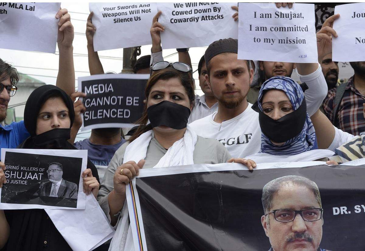 Journalists stage a protest against the killing of veteran journalist Shujaat Bukhari and recent remarks by BJP leader Lal Singh that were denounced as a threat towards media workers in Kashmir, in Srinagar on Tuesday. (AFP)