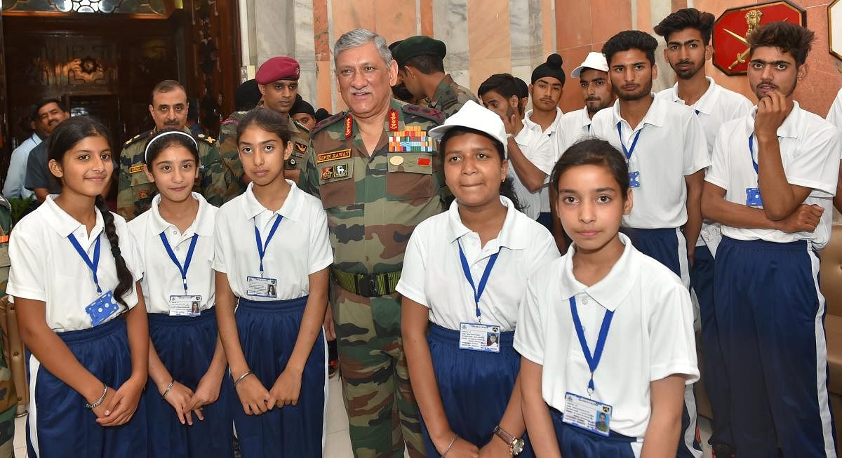 Chief of Army Staff, General Bipin Rawat poses with students from Jammu and Kashmir on National Integration/Educational Tour organised by the Army, in New Delhi on Friday. (PTI Photo)