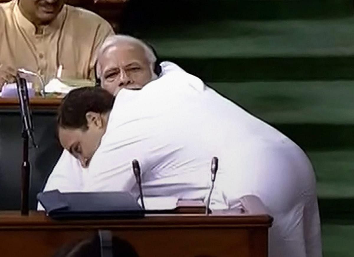 Congress President Rahul Gandhi hugs Prime Minister Narendra Modi after his speech in the Lok Sabha on 'no-confidence motion' during the Monsoon Session of Parliament, in New Delhi on Friday. PTI Photo