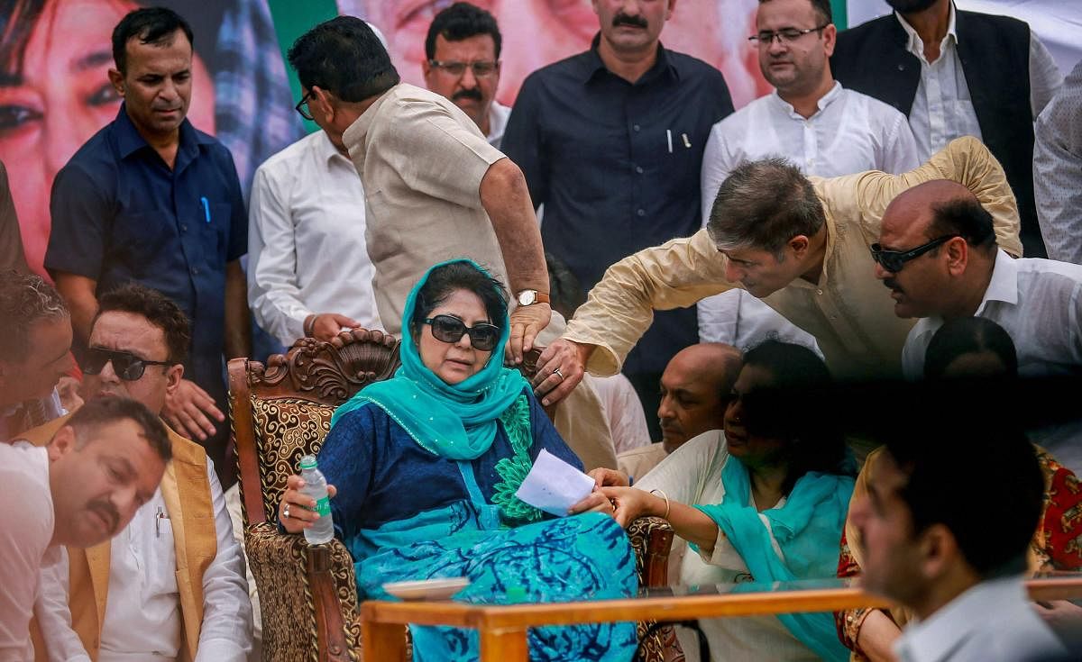 Jammu: PDP President and former chief minister Mehbooba Mufti being offered water after she complained of uneasiness while addressing a public rally on the 19th Foundation Day of the party in Jammu on Monday, July 30, 2018. (PTI Photo)(PTI7_30_2018_000112