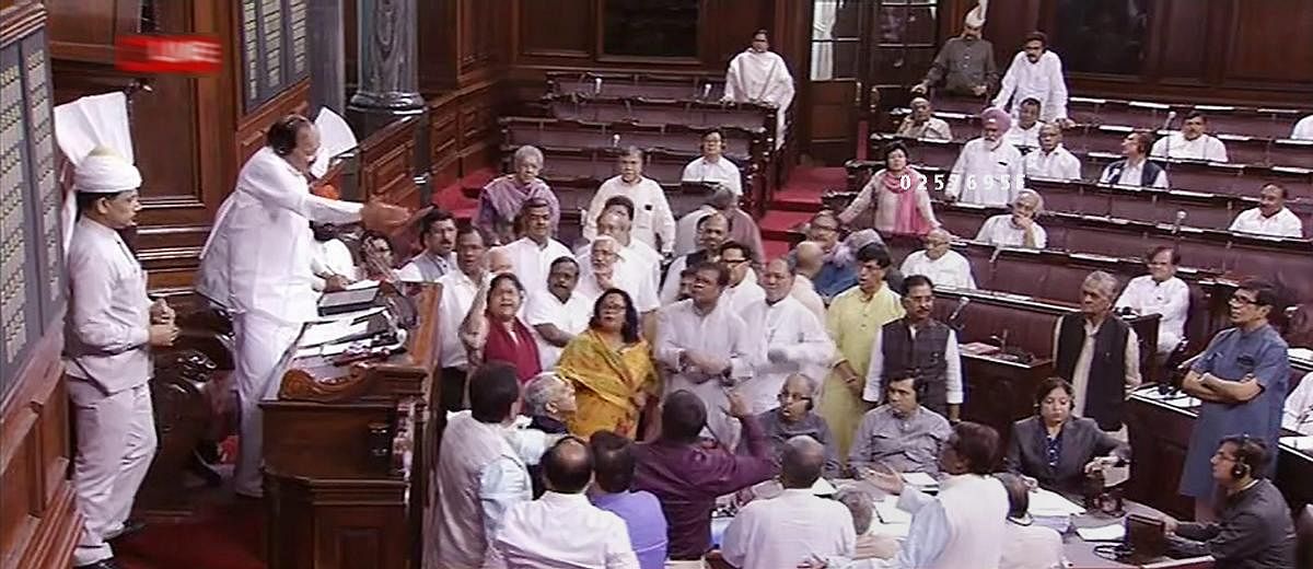 Rajya Sabha Chairman M Venkaiah Naidu tries to pacify the Opposition members who were protesting in the well of the House during the Monsoon session of Parliament in New Delhi on Tuesday. RSTV GRAB via PTI