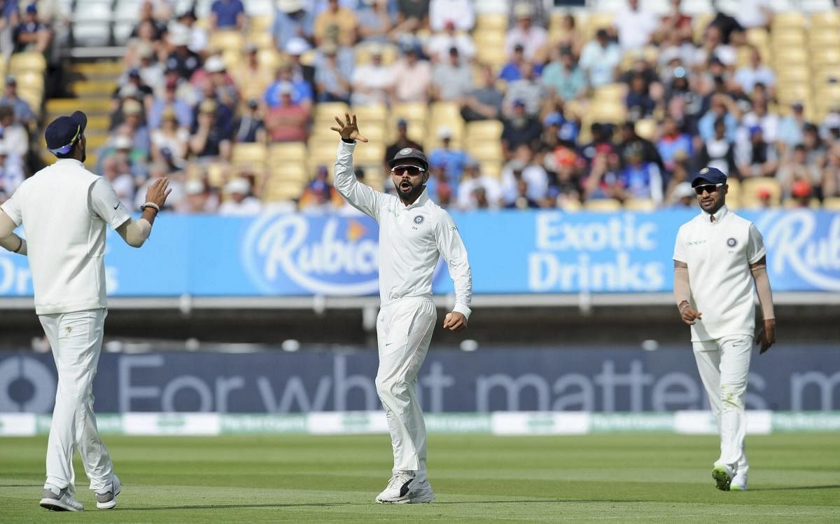 Indian captain Virat Kohli mimics the mic-drop celebration after dismissing his English counterpart Joe Root with a direct hit. AP/PTI